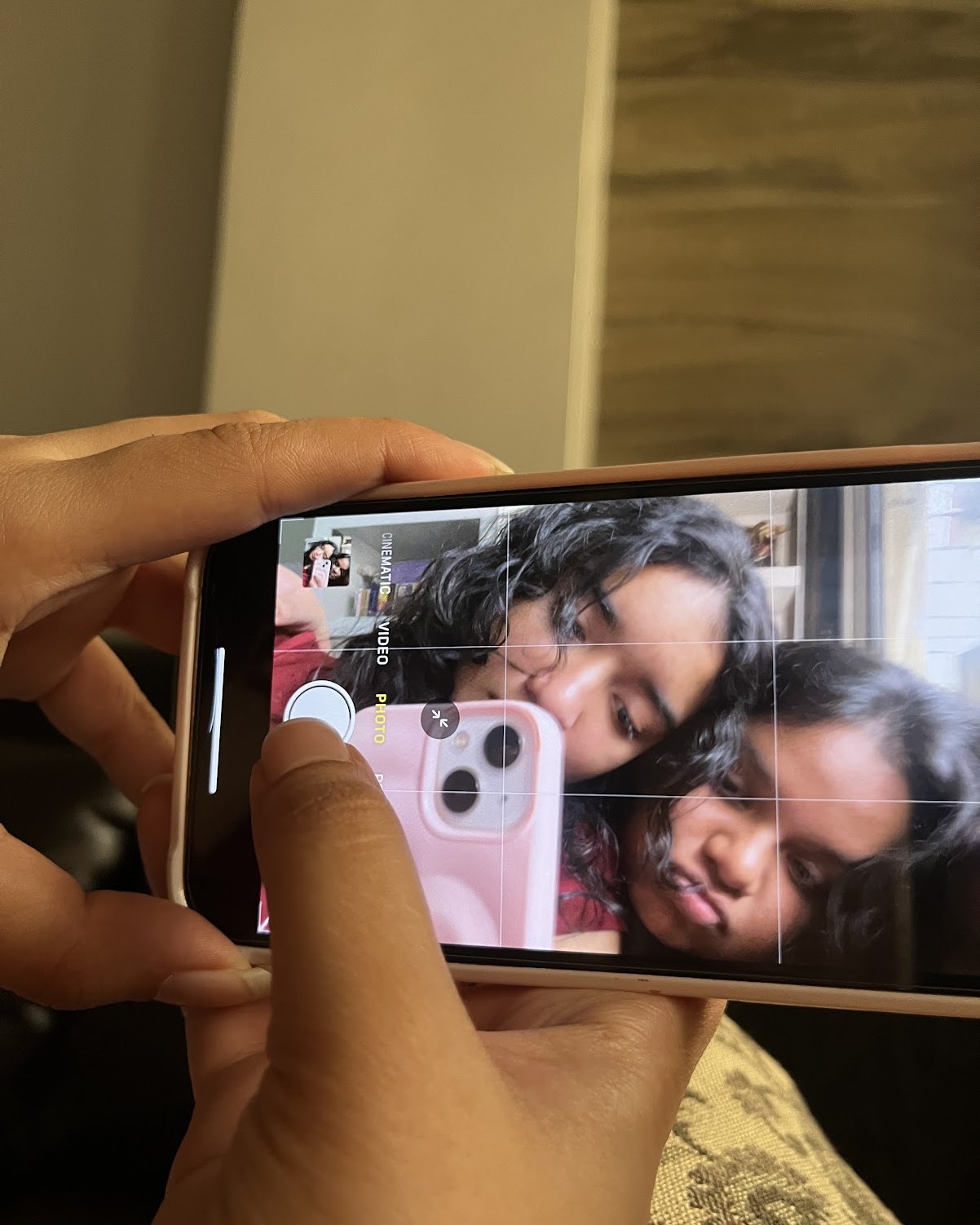 A phone held up, the two of us on its screen